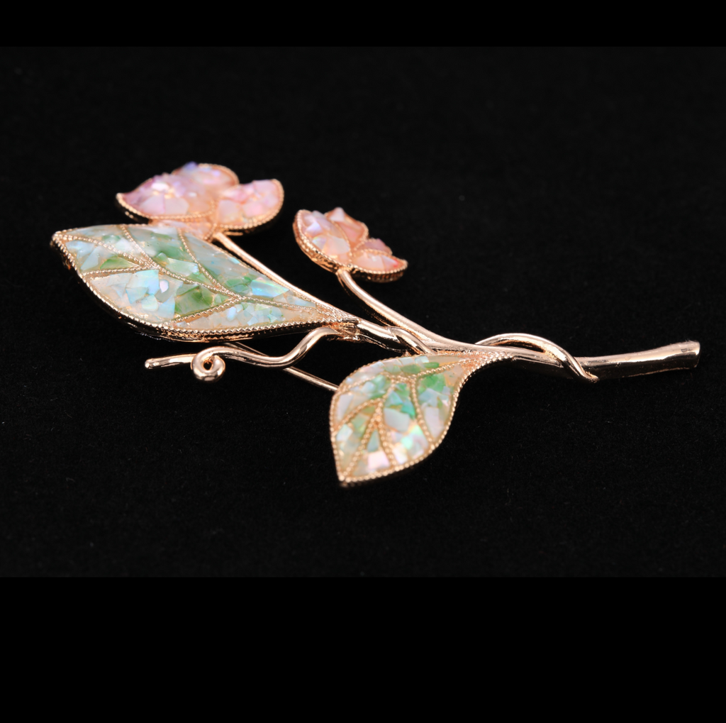 close up of mother of pearl,nacre shell brooch＆lily brooch on black