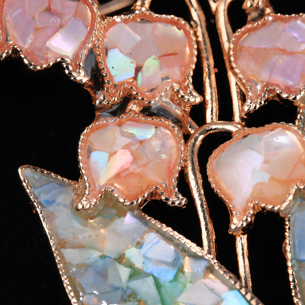 Close up of mother of pearl,nacre shell brooch＆flower brooch on black