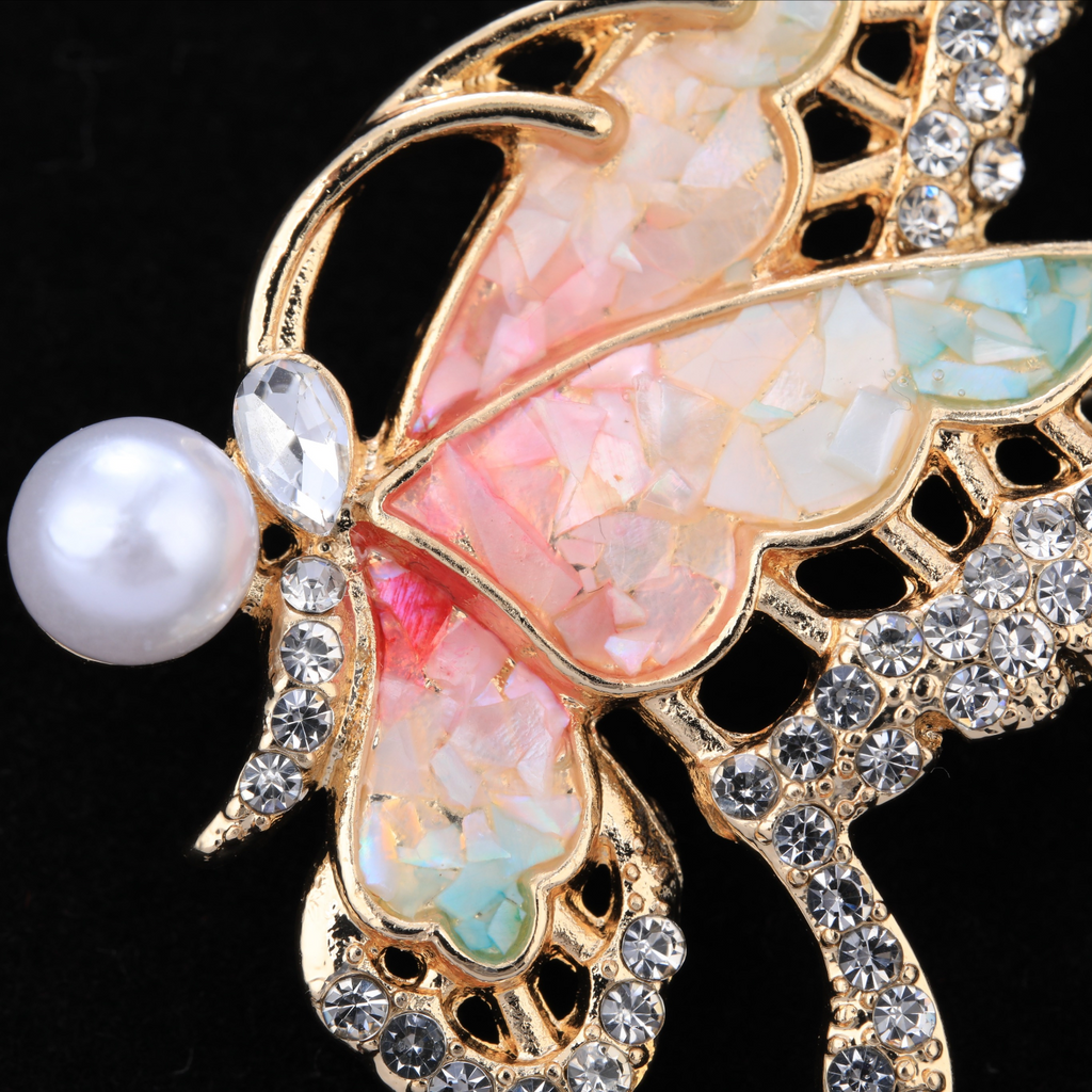 Close up of mother of pearl,nacre shell brooch＆Butterfly brooch with pink-blue wings on black