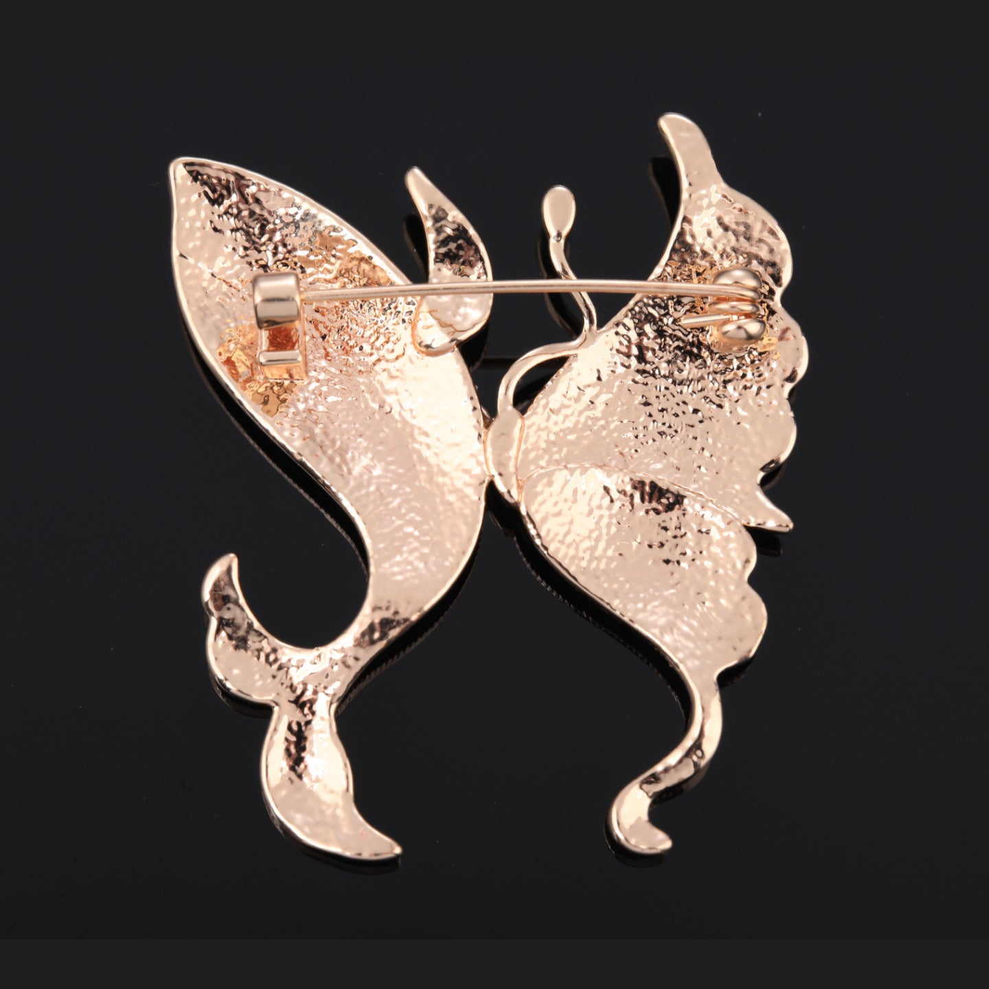 Back of butterfly mother of pearl brooch with pin clasp
