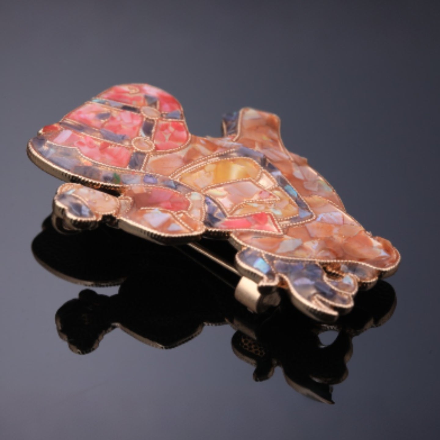 Close up of mother of pearl,nacre shell brooch＆Rocking Horse brooch with rose-red base