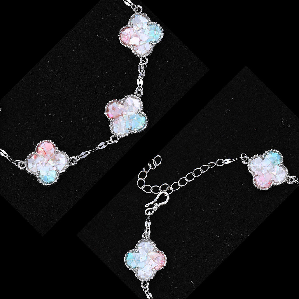 Close-up of clover charm’s iridescent mother of pearl inlay texture  
