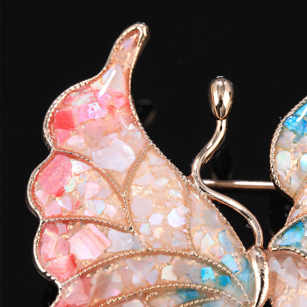 Close-up of mother of pearl,nacre shell brooch＆Butterfly brooch with pink-blue wings