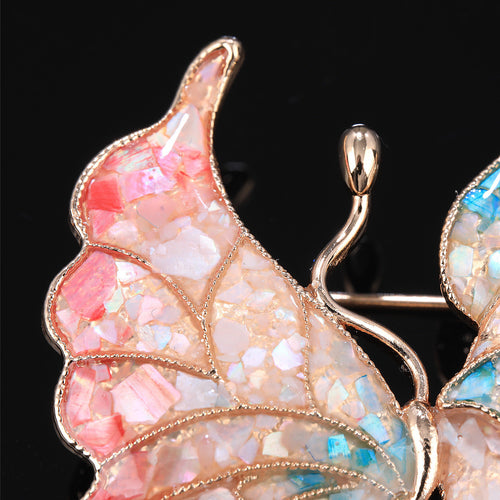 Close-up of mother of pearl,nacre shell brooch＆Butterfly brooch with pink-blue wings