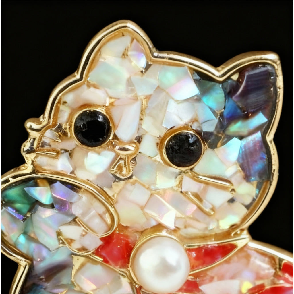 Close-up of Mother of Pearl Dancing Cat Brooch with Iridescent Shell Mosaic and Red Bow