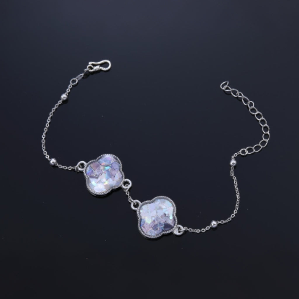  Close up of iridescent mother of pearl inlay on clover bracelet charm