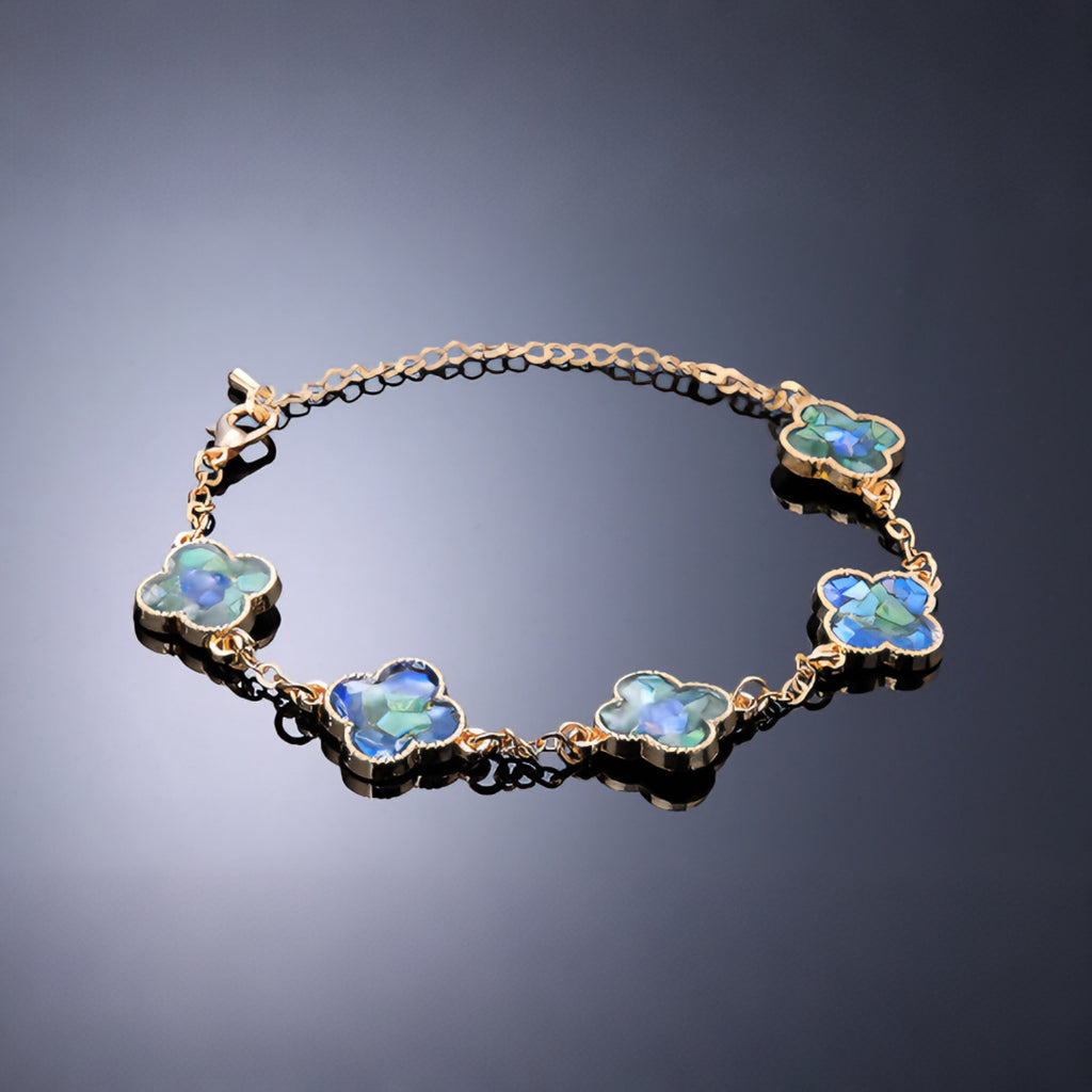 Detail of clover link with blue-green mother-of-pearl inlay  