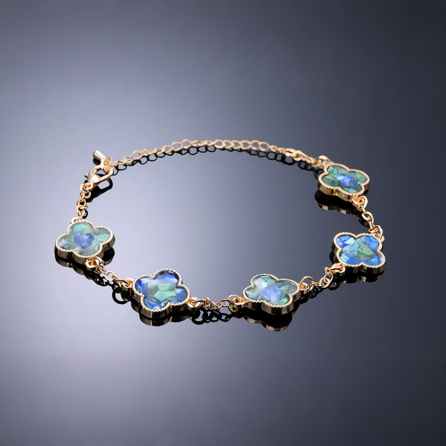 Detail of clover link with blue-green mother-of-pearl inlay  