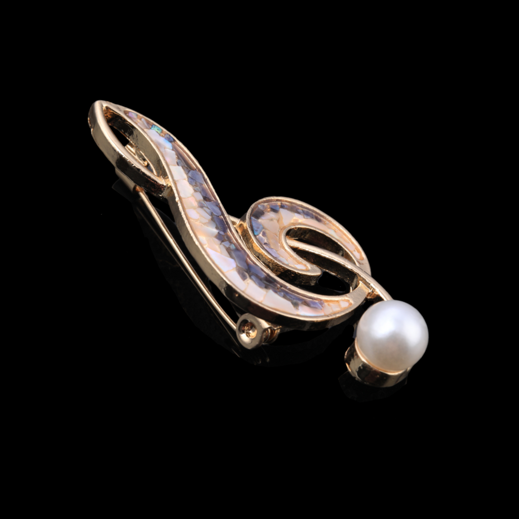  Close-up of Handmade iridescent treble clef mother-of-pearl brooch,nacre shell brooch
