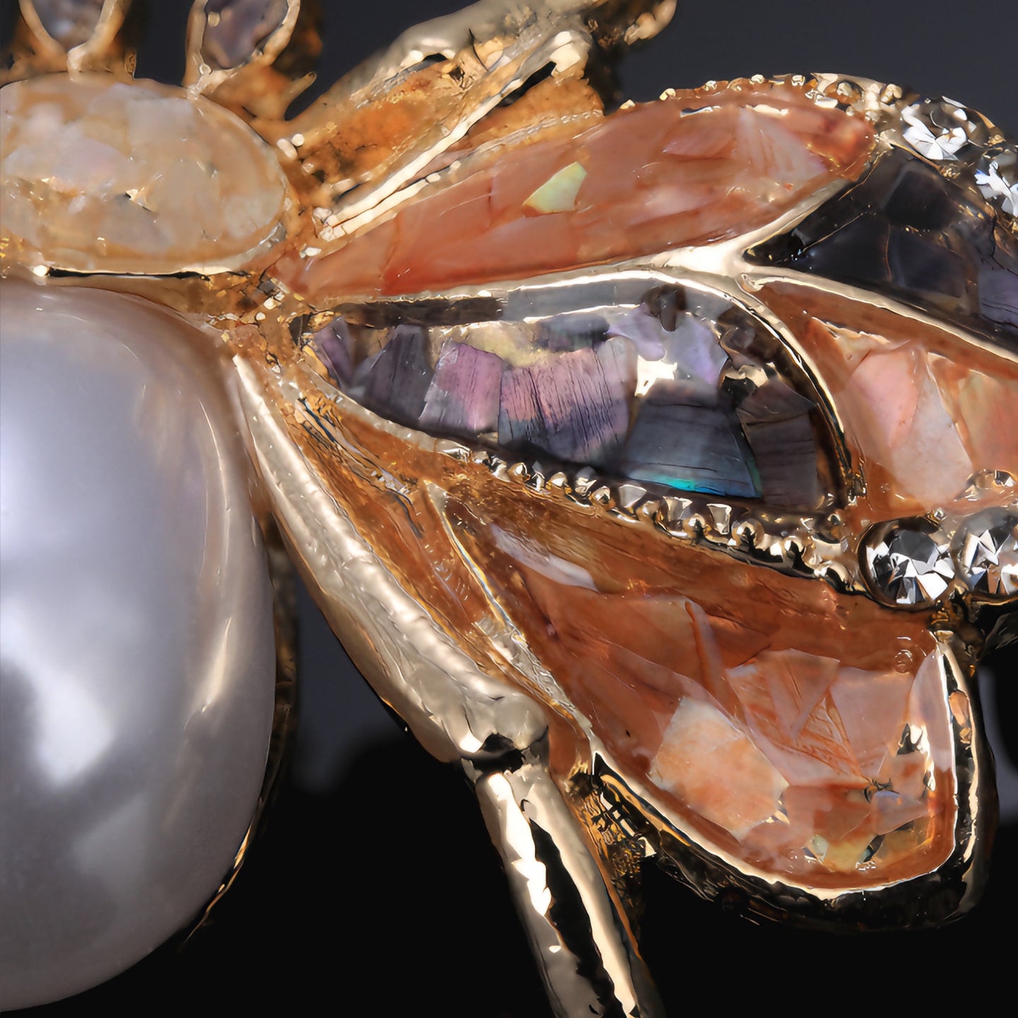 Close up of Handmade mother of pearl bee brooch ,nacre shell brooch with pearl center and crystal-trimmed wings  