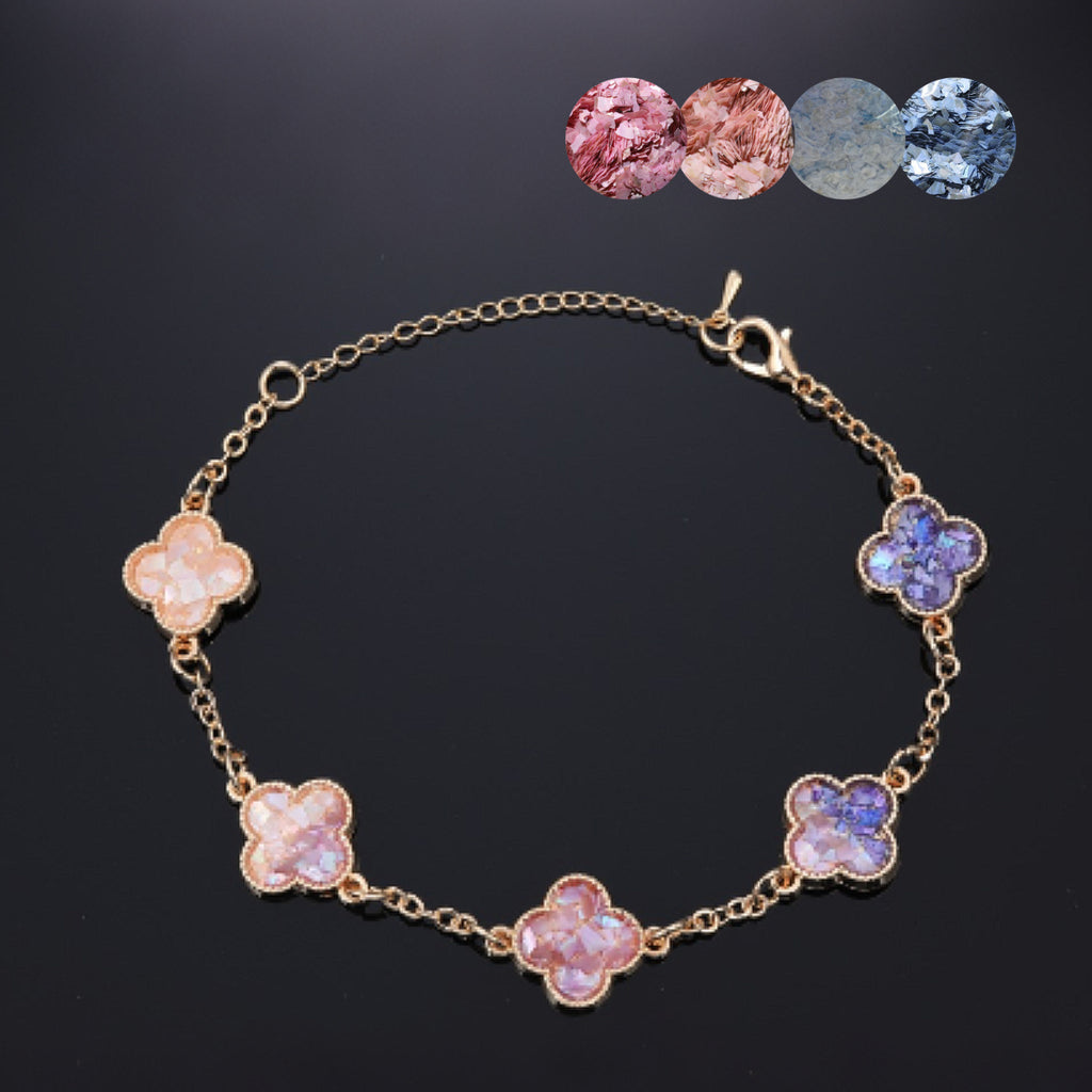  Handmade Gradient Mother of Pearl Clover Bracelet on black background—gold-toned with peach to purple inlay  