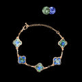  Iridescent mother of pearl clover bracelet (gold-tone metal) on black background  